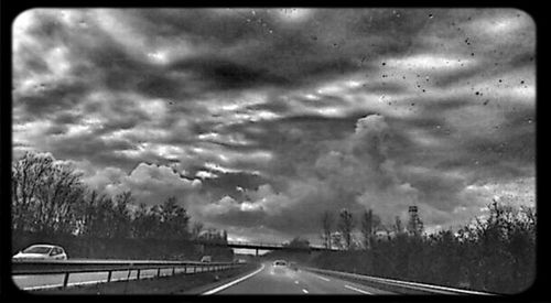 Road passing through dramatic sky