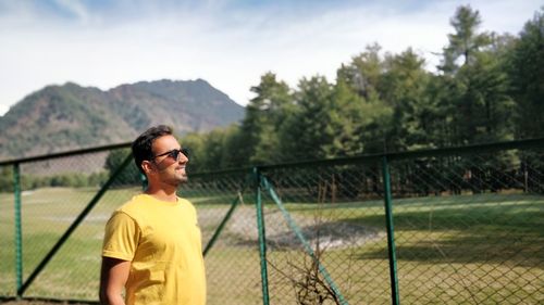 Man standing against trees