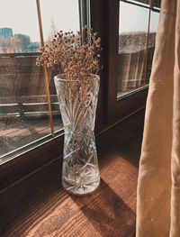 Close-up of glass vase on table at home