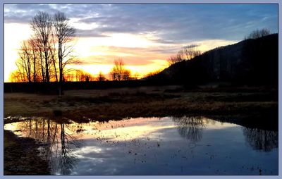 Scenic view of lake at sunset