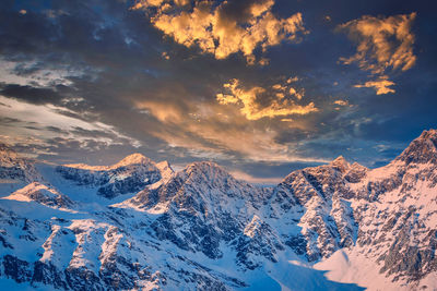 Scenic view of snowcapped mountains against sky during sunset