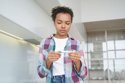 Portrait of young woman using mobile phone