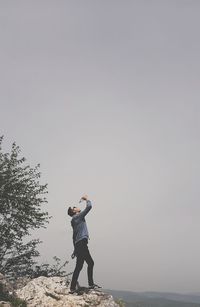 Full length of man standing on land against sky