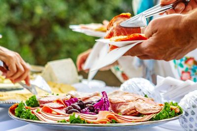 Midsection of person holding food on table