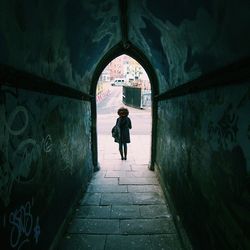 Woman standing in tunnel