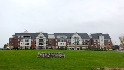 Lawn by building against sky