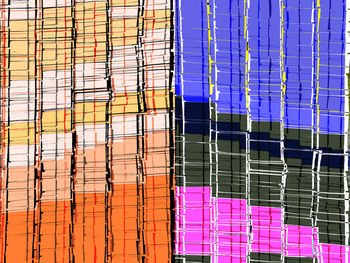 Low angle view of multi colored glass building