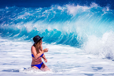 Woman wading into ocean