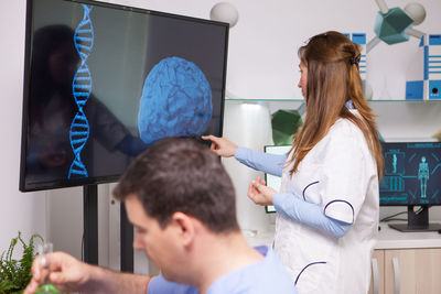 Side view of doctor examining patient at clinic