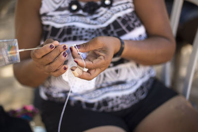Midsection of woman crocheting