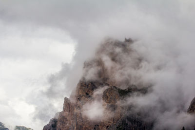 Low angle view of clouds over mountain