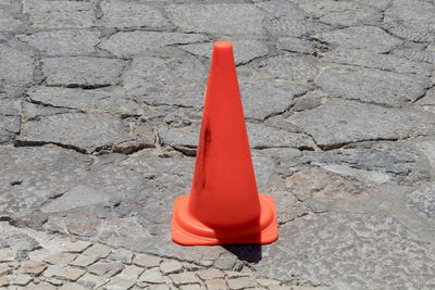 Traffic cone on road during sunny day