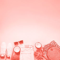 High angle view of pink balloons on table against white background