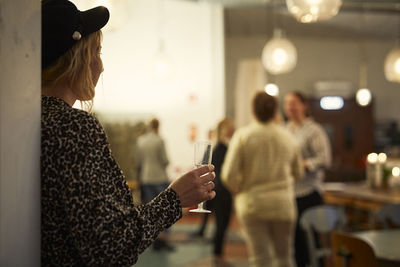 Woman with flute at meeting in cafe