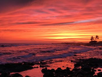 Scenic view of sea against orange sky