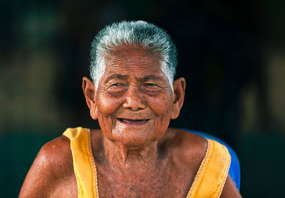 Close-up portrait of smiling senior woman outdoors