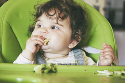 Portrait of cute boy eating baby