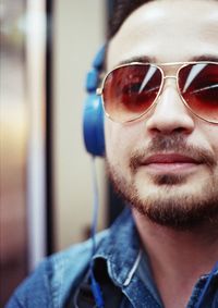 Close-up portrait of man wearing sunglasses