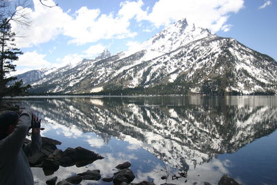 Scenic view of lake and snowcapped mountains against sky