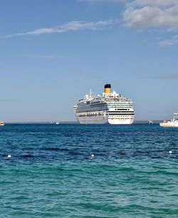 Ship sailing in sea against sky