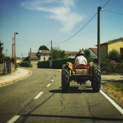 Vehicles on road against sky