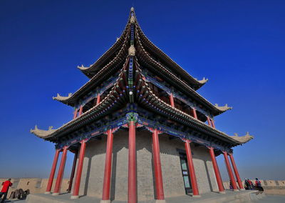 Low angle view of traditional building against blue sky