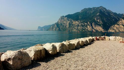 Scenic view of sea and mountains against sky