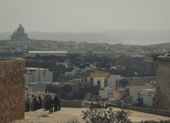 People standing at town square against clear sky