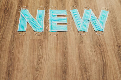 High angle view of text on hardwood floor