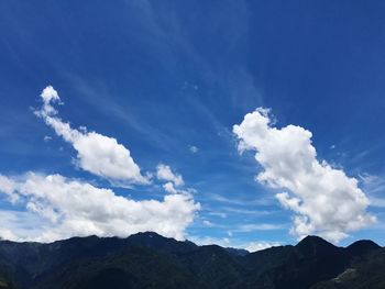 Scenic view of mountains against blue sky