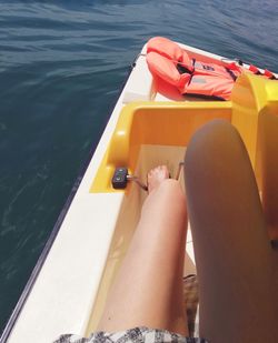 Low section of man sitting on boat in sea