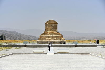 People at temple against clear sky