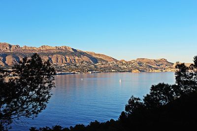 Scenic view of mountains against clear blue sky