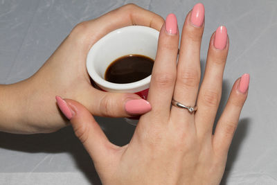 Midsection of woman holding coffee cup