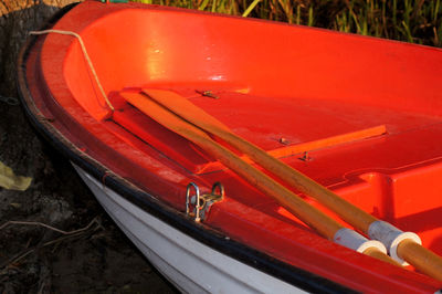 High angle view of red boat moored on shore