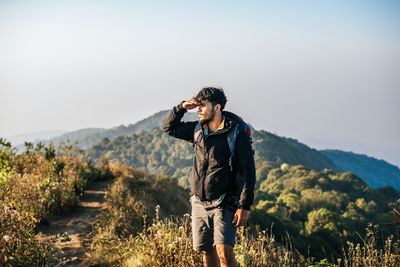 Man standing on mountain against clear sky