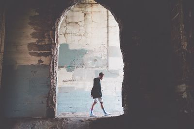 Man walking in corridor of historic building