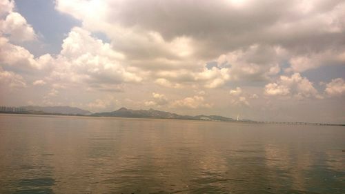 Scenic view of sea against cloudy sky