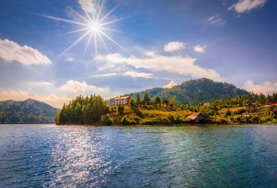 Scenic view of lake and mountains against sky