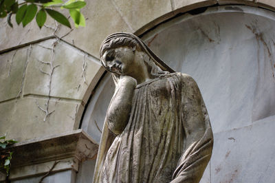 Low angle view of statue against building