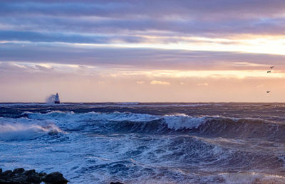 Scenic view of sea against sky during sunset