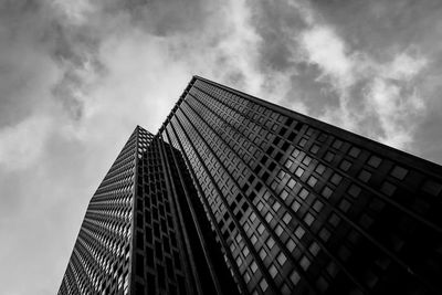 Low angle view of modern building against cloudy sky