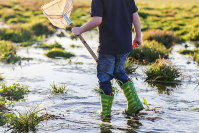 Boy walking in shallow water