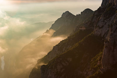 High section of rocky landscape and clouds