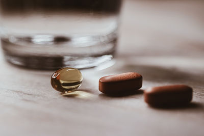 Close-up of tablets with glass on table