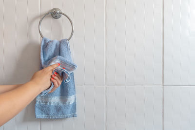 Midsection of woman holding umbrella at home