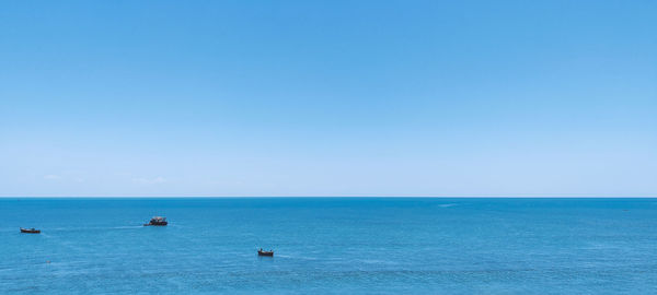 Scenic view of sea against clear blue sky