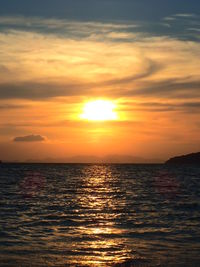 Scenic view of sea against romantic sky at sunset