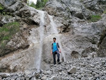 Full length of boy standing on rock