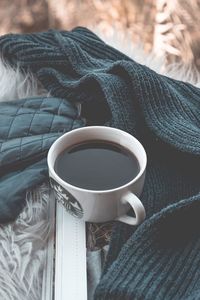 High angle view of coffee cup on bed